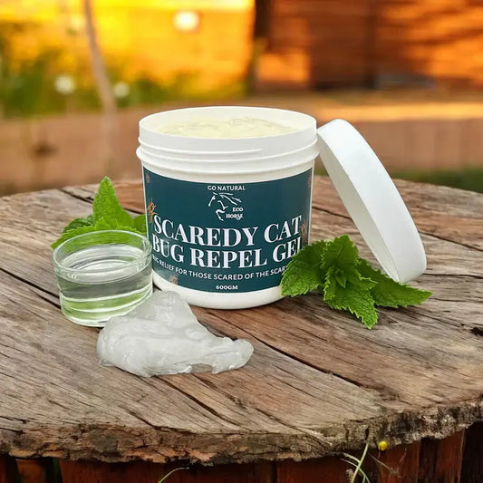 Eco Horse Scaredy Cat Bug Repel Gel with natural ingredients for insect protection, shown with a glass and green leaves.